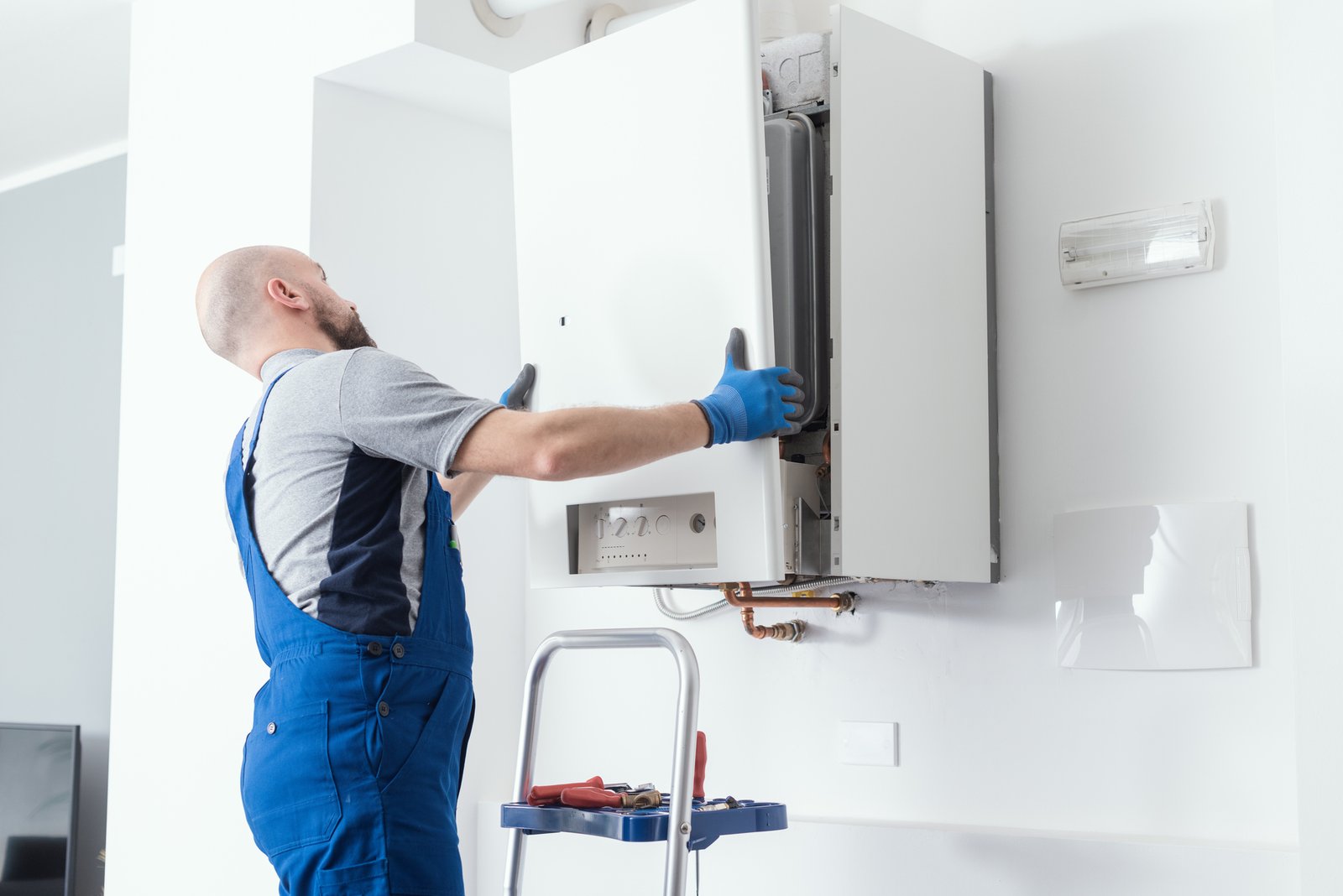 plumber dunstable installing new boiler system in home with modern equipment
